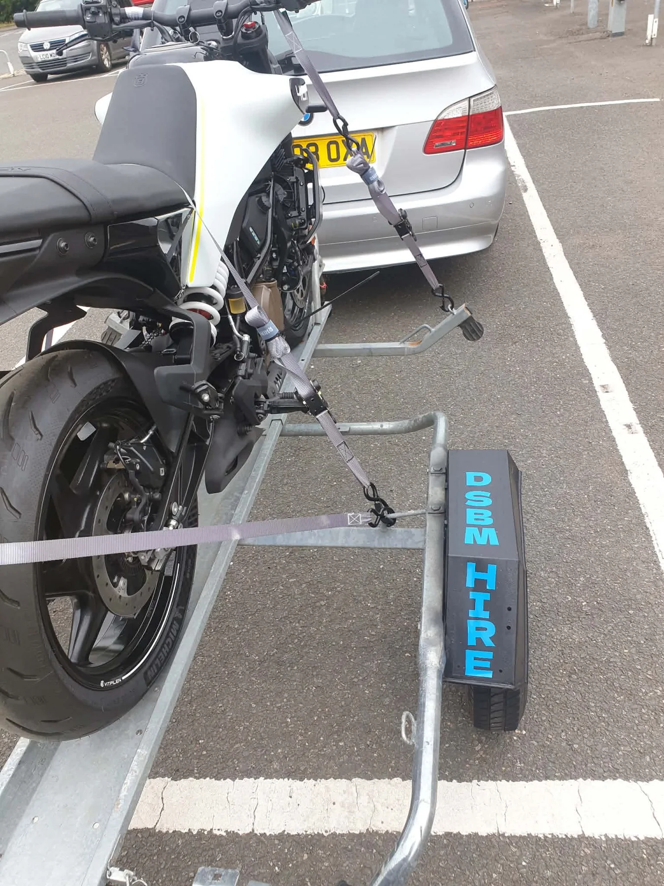 Motorcycle secured using included ratchet straps